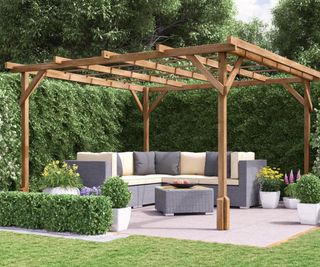 wooden pergola in garden over patio and grey garden furniture