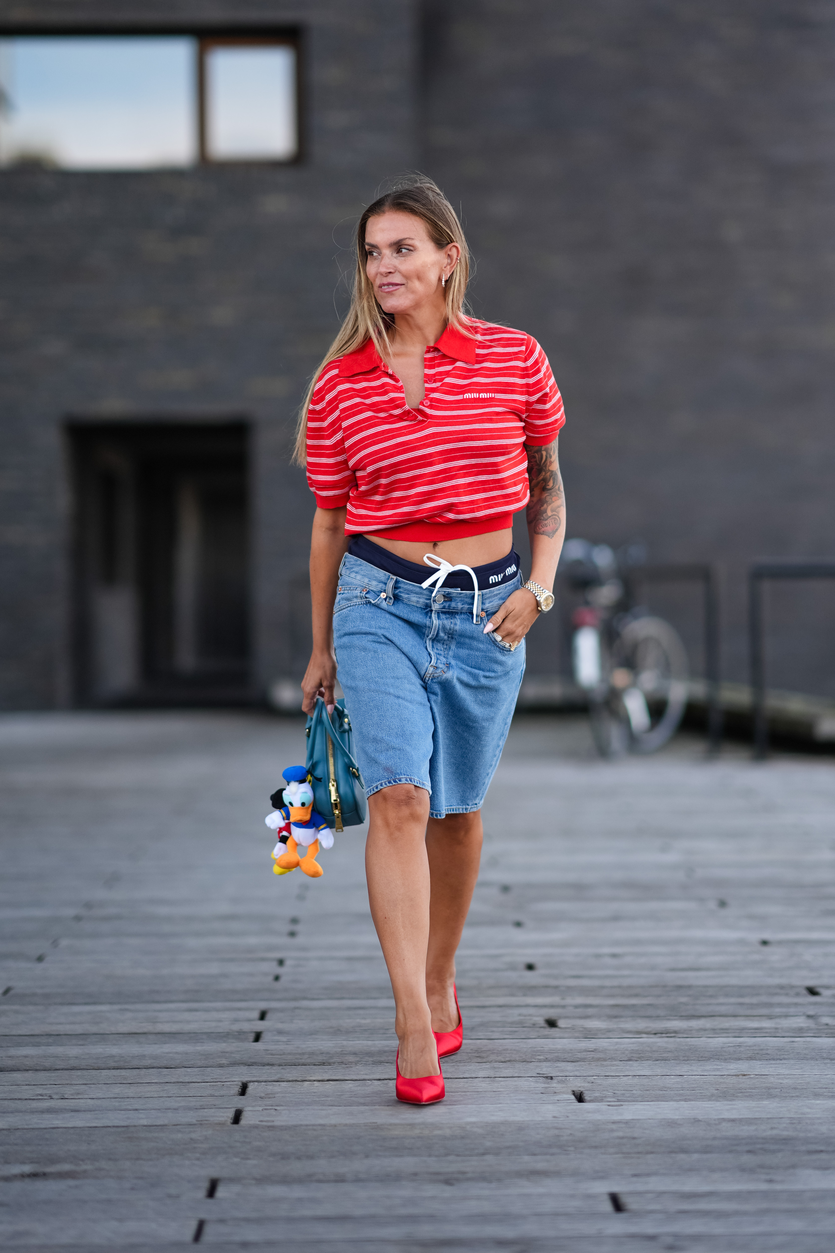 Woman wearing a polo shirt and jorts