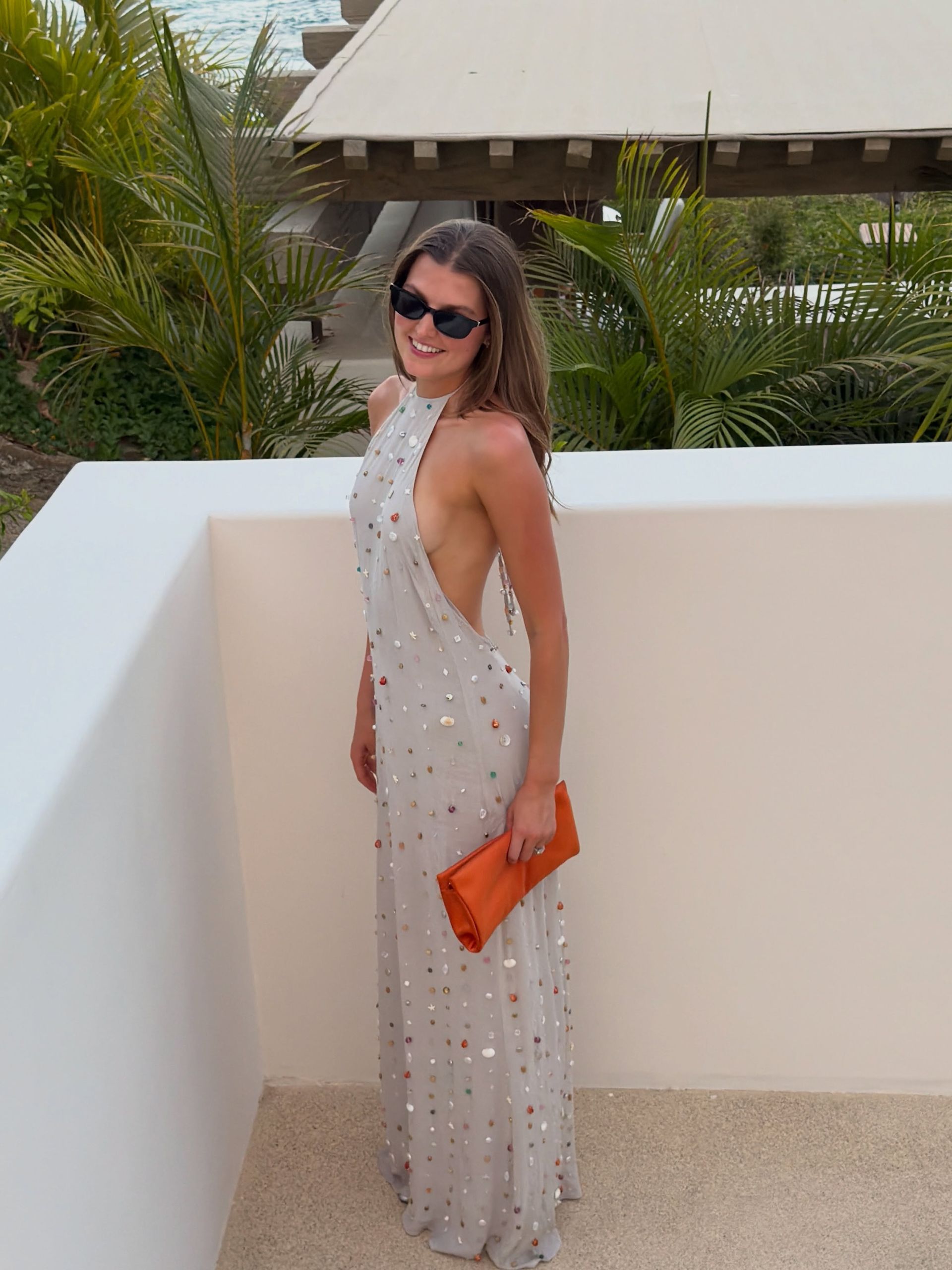 Woman holding an orange handbag.