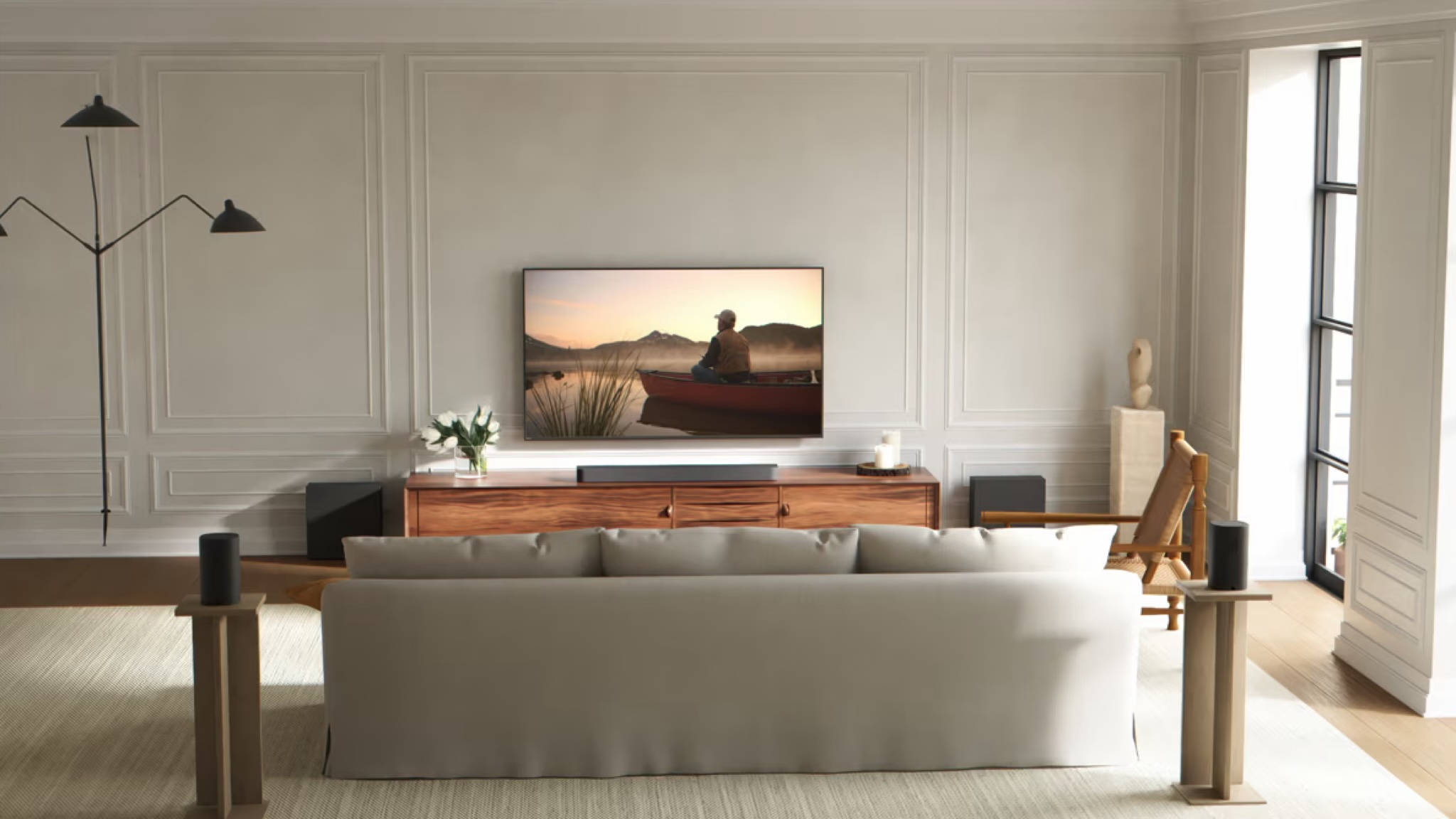 Promotional image of the Sony Bravia Theater Bar 7 underneath a TV in a neutrally decorated room