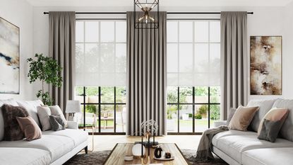 Large window curtain ideas with a white sheer blind under heavier grey curtains in a living room