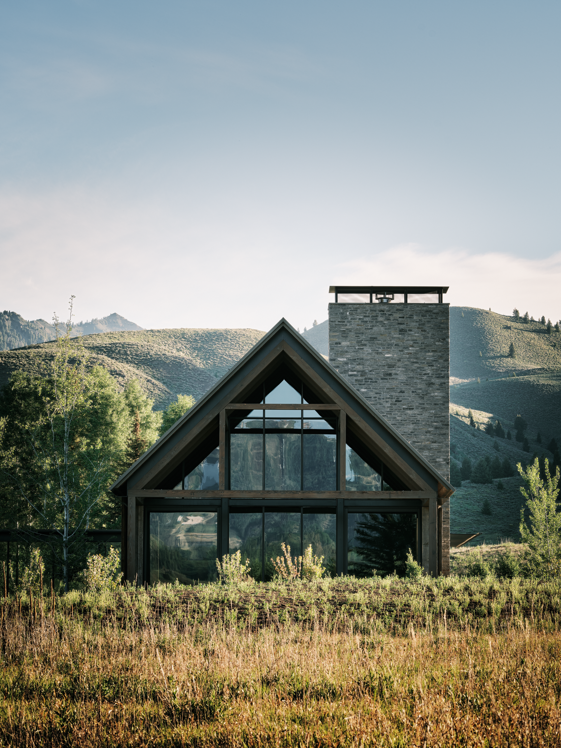 Three Barns by Field Architecture, a rural american home designed to look like a collection of old wooden barns