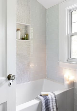 white bathroom with white and blue subway tiles