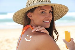 Woman applying sunscreen