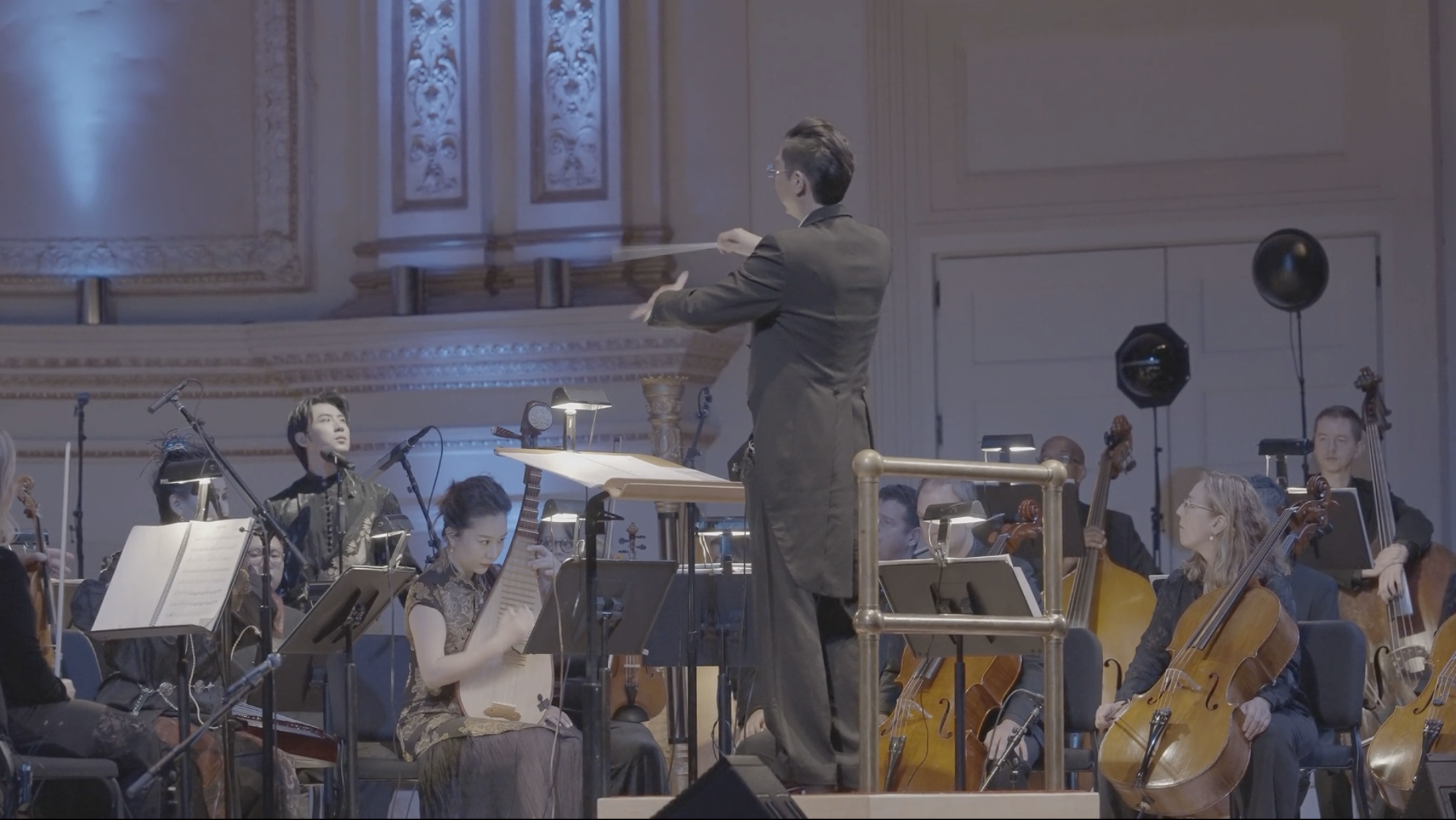 The conductor and orchestra playing the Black Myth: Wukong Global Concert tour stop in New York's Carnegie Hall