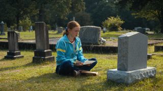Max sitter framför Billys grav på dagtid i Stranger Things säsong 4