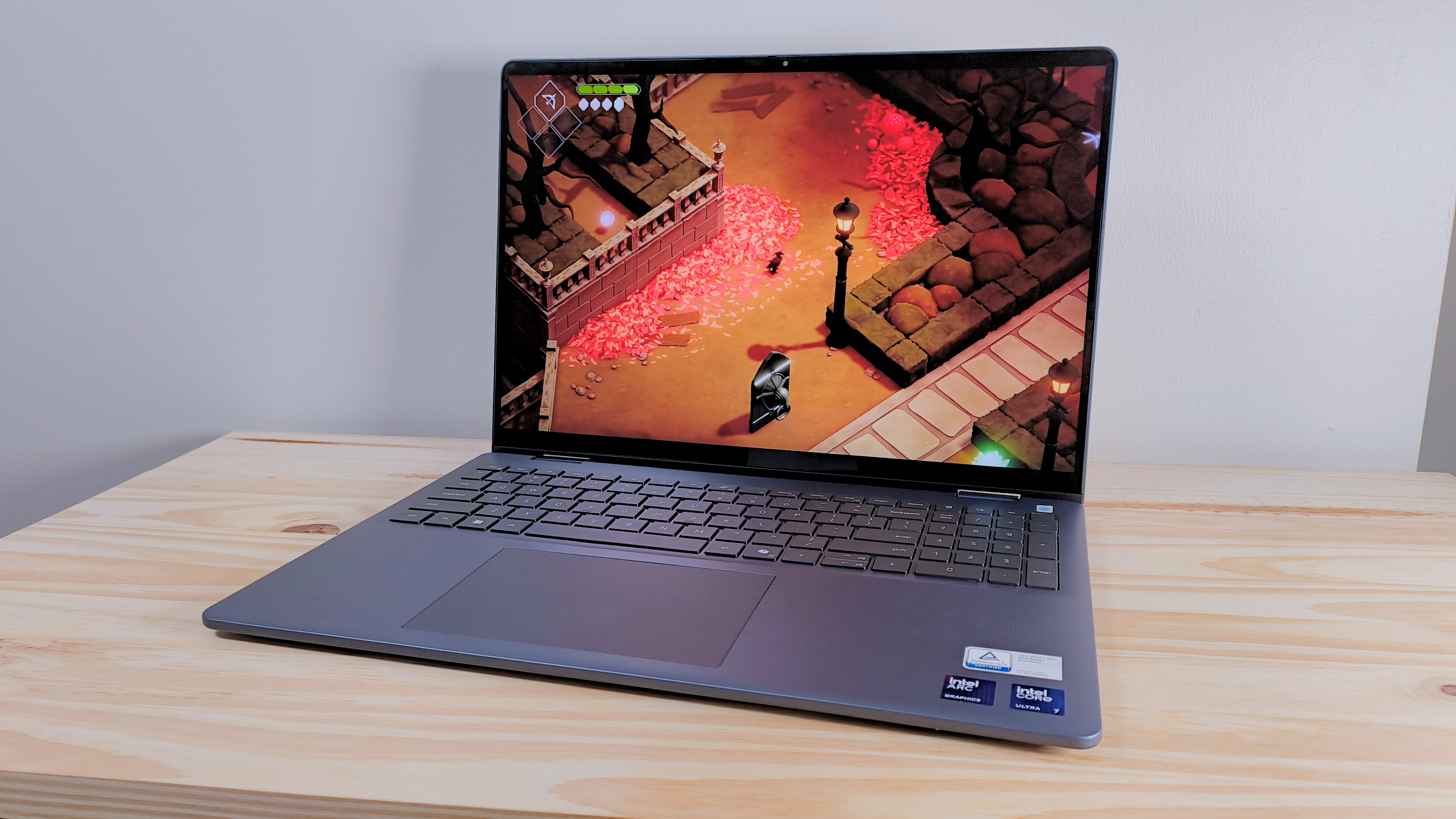The Dell 16 Plus 2-in-1 on a wood table running Death's Door