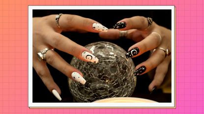 Two hands pictured with white and black Halloween nail designs/ in a pink and orange gradient template