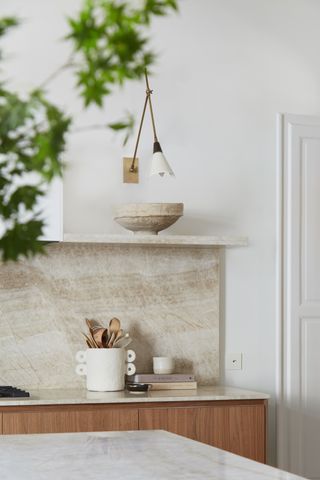 A kitchen shelf with wall light