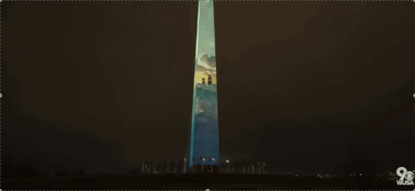 The Washington Monument lit with projection mapped ships sailing the Atlantic. 