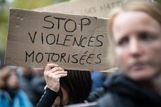 A demonstrator holds a sign reading ''Stop motorised violence'' during a gathering at the Place de La Republique in Paris, France