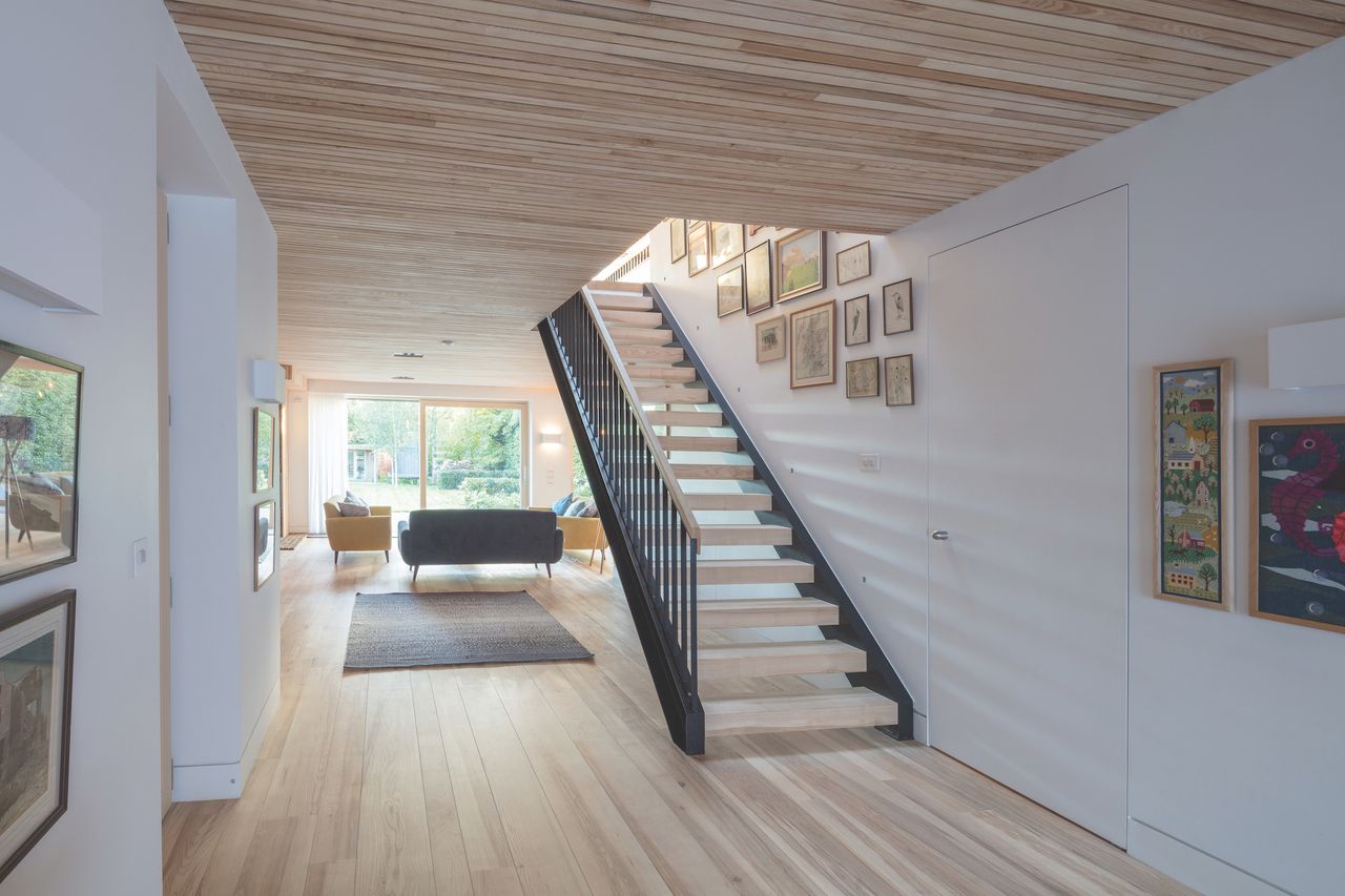 wood lined staircase in self build hallway