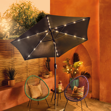 Aldi LED parasol on a Mediterranean patio garden.