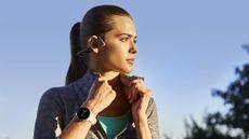 Young woman turning her collar up wearing the Garmin Forerunner 245 GPS running watch
