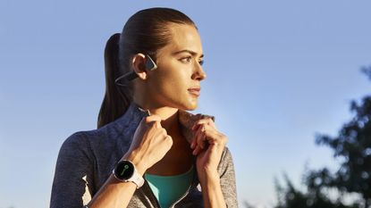 Young woman turning her collar up wearing the Garmin Forerunner 245 GPS running watch