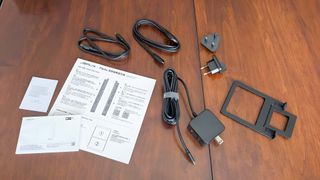 Cables, adapters, stand, and manuals that come with JSAUX FlipGo Pro 16.