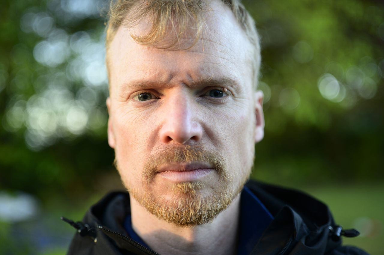Portrait of a man during golden hour with dappled light through trees, taken with the Viltrox AF 50mm F2 Air lens