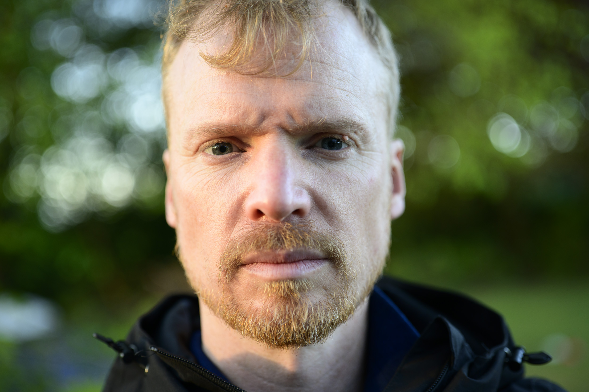 Portrait of a man during golden hour with dappled light through trees, taken with the Viltrox AF 50mm F2 Air lens