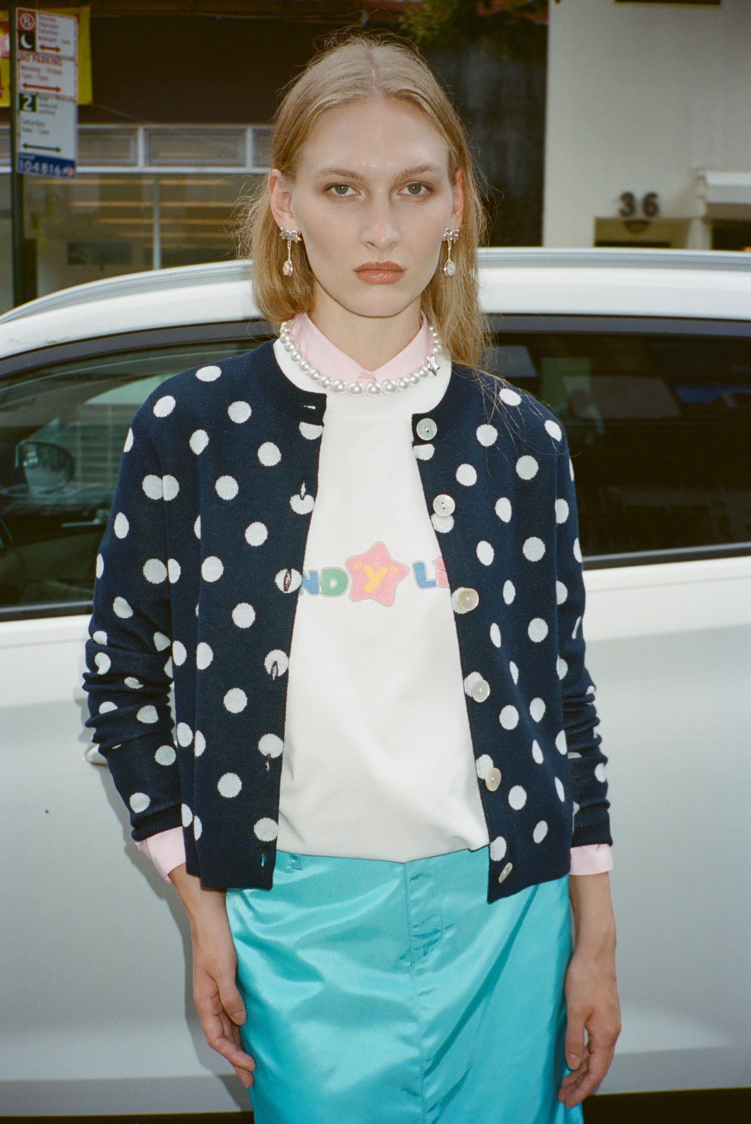 Model wearing a Sandy Liang polka dot sweater.