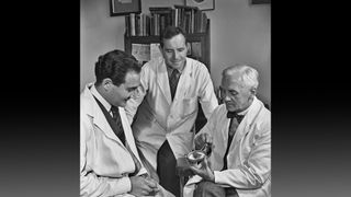 Scottish microbiologist Sir Alexander Fleming (R), shows a petri dish of bacteria culture to British gynecologist Jack Suchet (L) in 1945.