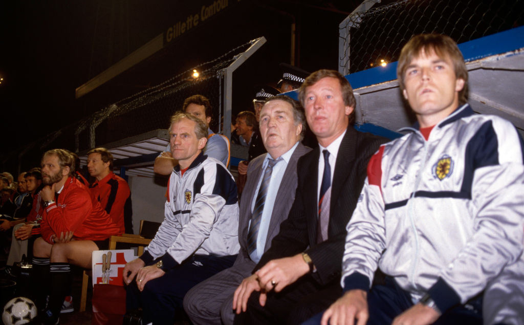 Scotland manager Jock Stein (3rd r) and Alex Ferguson (2nd r) look on from the bench during the 1986 FIFA World Cup Qualifier between Wales and Scotland at Ninian Park on September 10, 1985 in Cardiff, Wales.