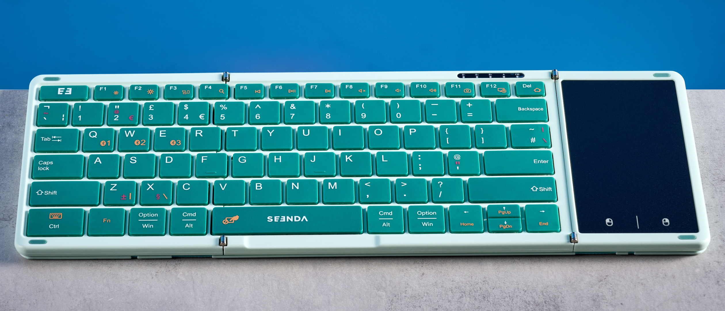 Seenda Foldable Bluetooth Keyboard with Touchpad pictured in front of a blue background.