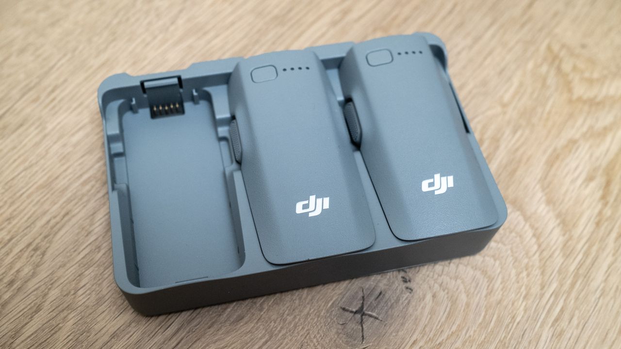 DJI Neo 2 battery charging hub on a wooden floor