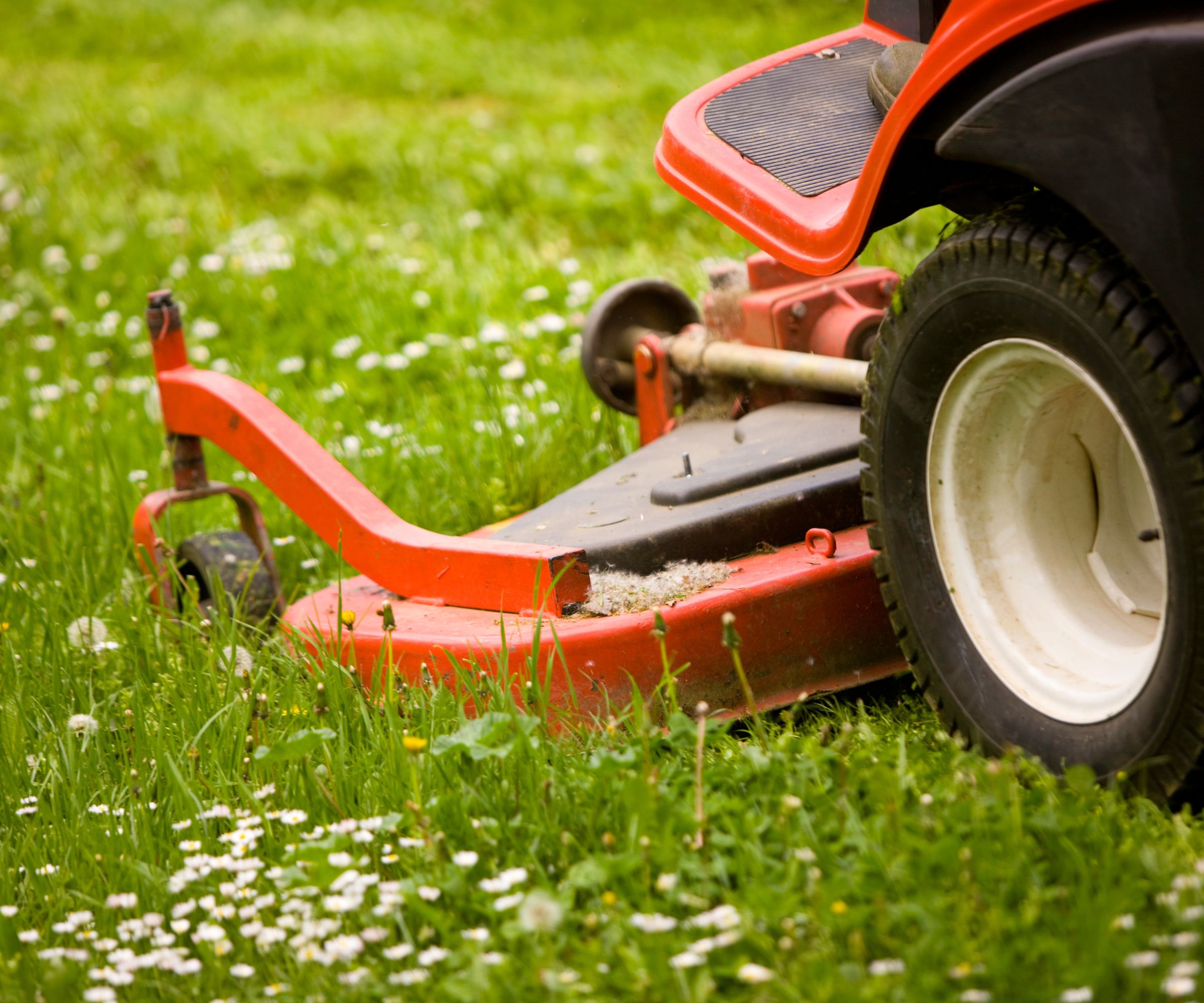 A closeup of the cutting deck of a zero-turn riding lawn mower