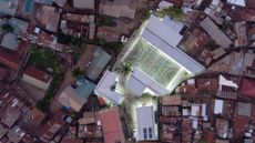 aerial view of town, brightly lit Uganda community centre in middle