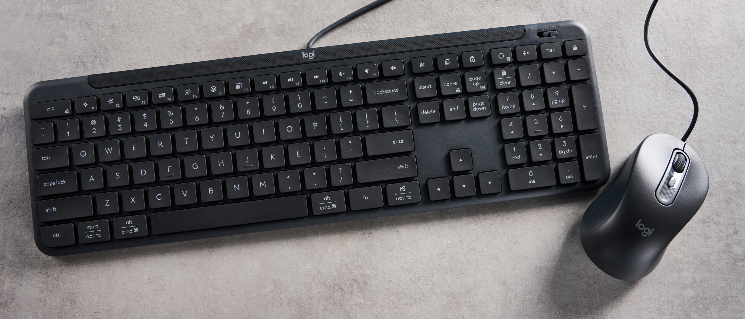The Logitech K620 keyboard in a graphite grey colorway photographed as part of the MK625 como on able and white background.