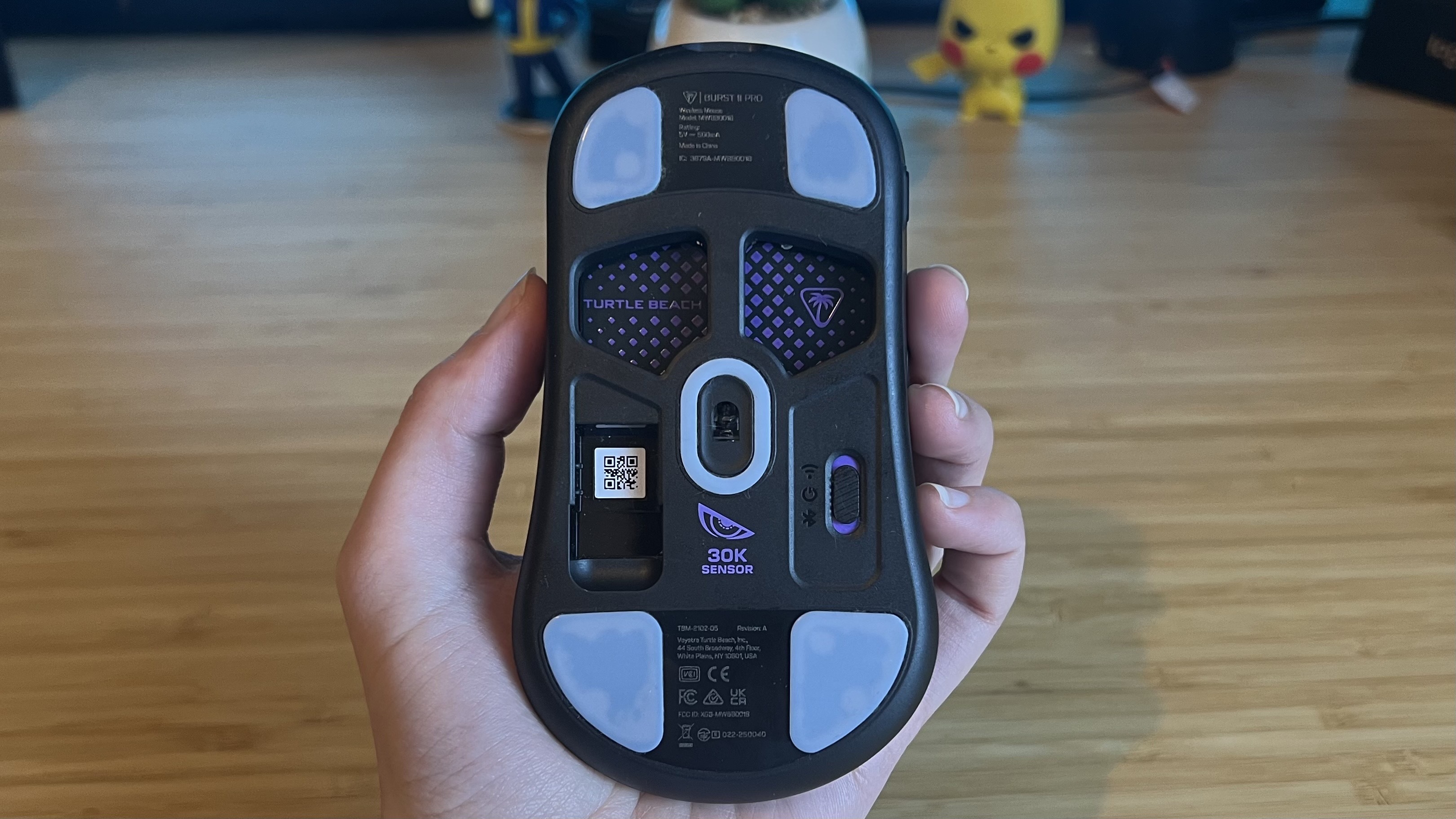 Underside of Turtle Beach Burst 2 Pro gaming mouse showing cut-outs and sensor