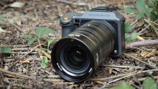 Hasselblad X2D II 100C with Hasselblad XCD 35-100E lens on the floor of a woodland setting