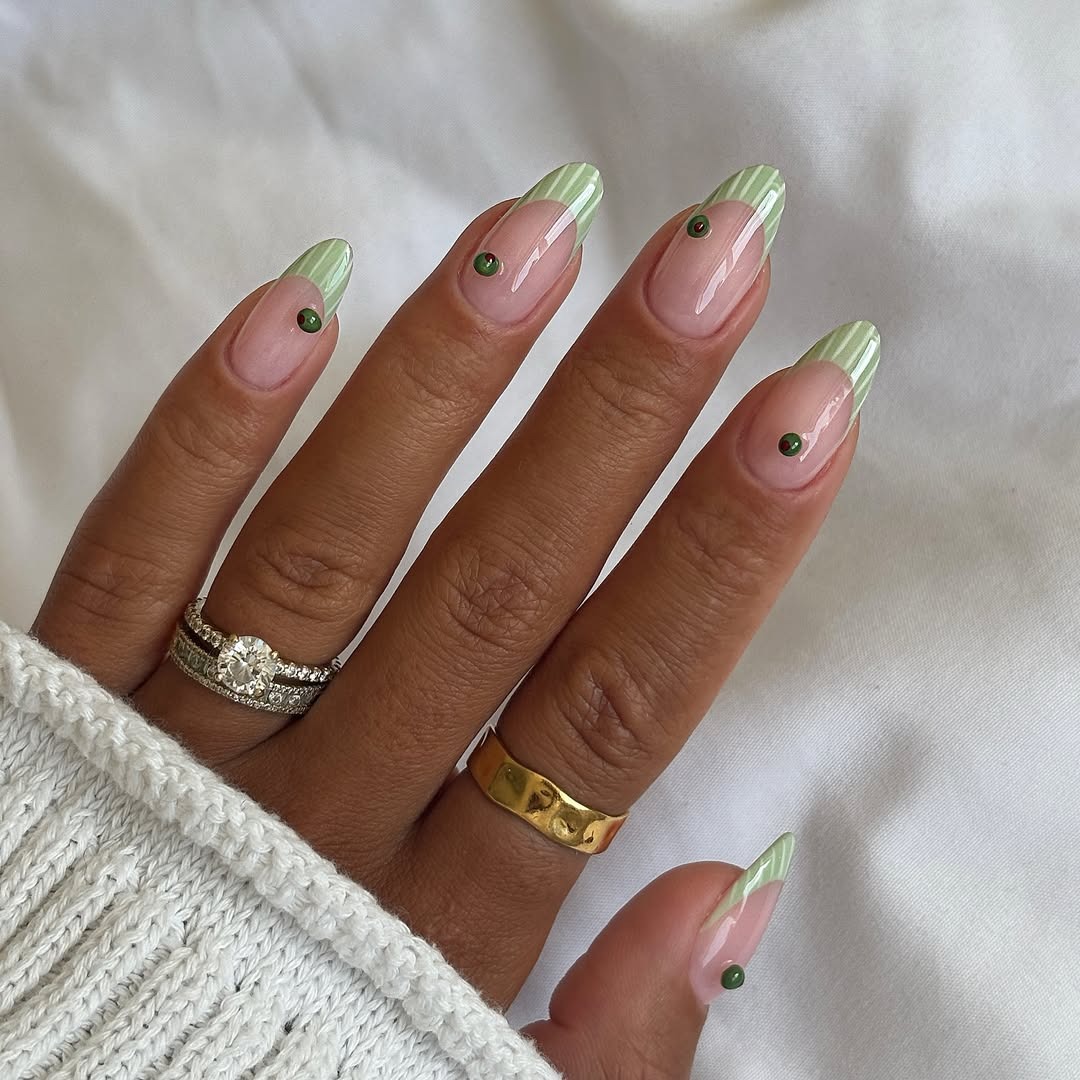 Striped sage green nails with 3D olive decals.