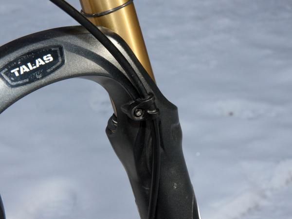 The brake hose is tidily secured to the arch.