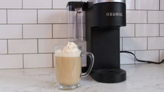 Coffee in front of Keurig K-Supreme SMART coffee maker