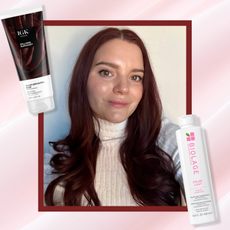 Brooke knappenberger red hair with burgundy border with igk color-depositing mask and biolage colorlast shampoo overlaid pink wave background 