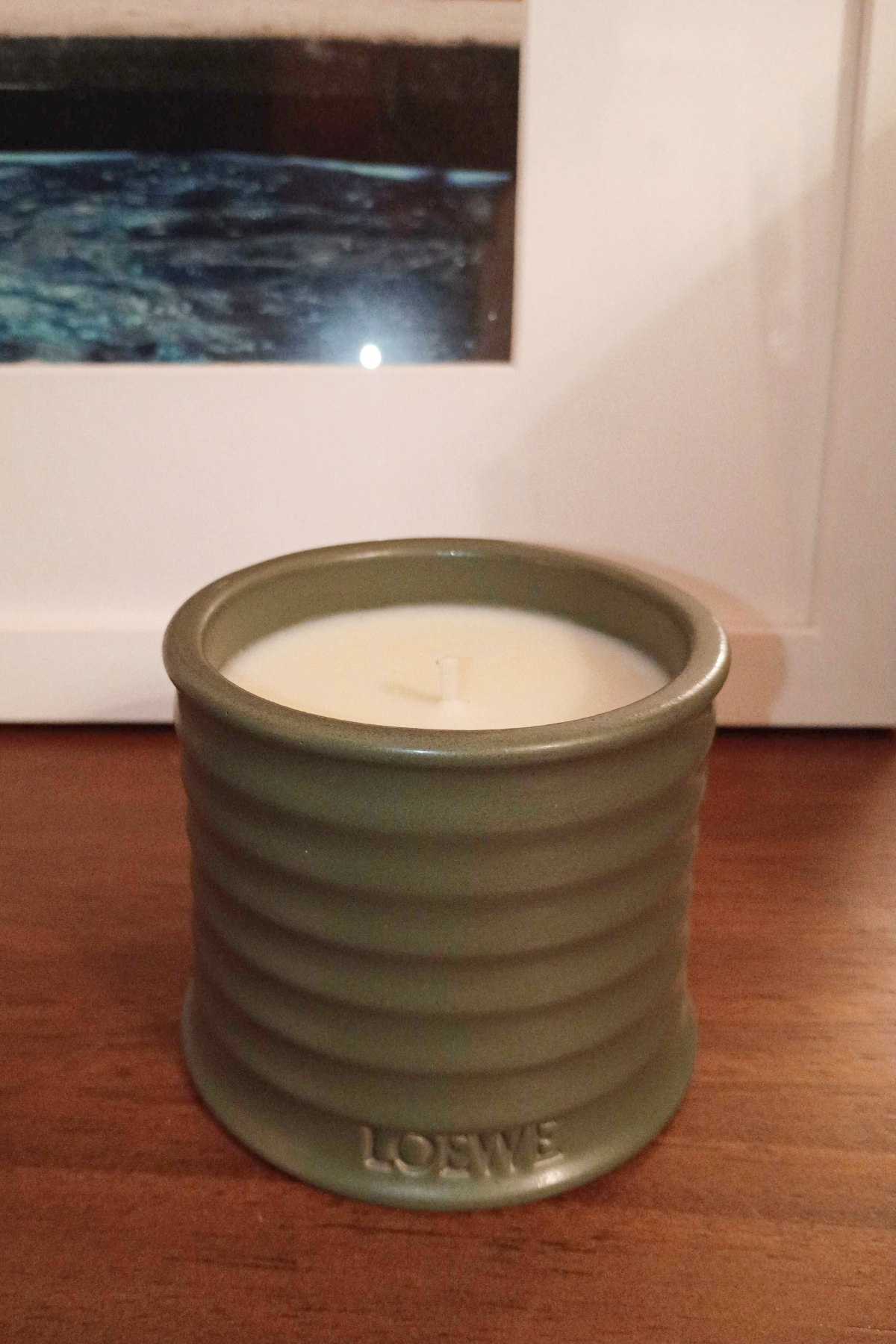 loewe marihuana candle in army colored jar on a wood background
