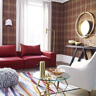 living room with printed wallpaper on wall and red sofaset with cushions