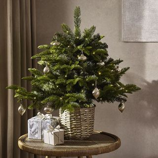 mini artificial christmas tree on a side table