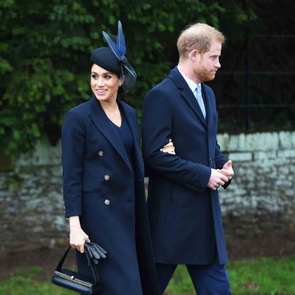 Clothing, Uniform, Standing, Suit, Outerwear, Formal wear, Gesture, Academic dress, Coat, Overcoat, 