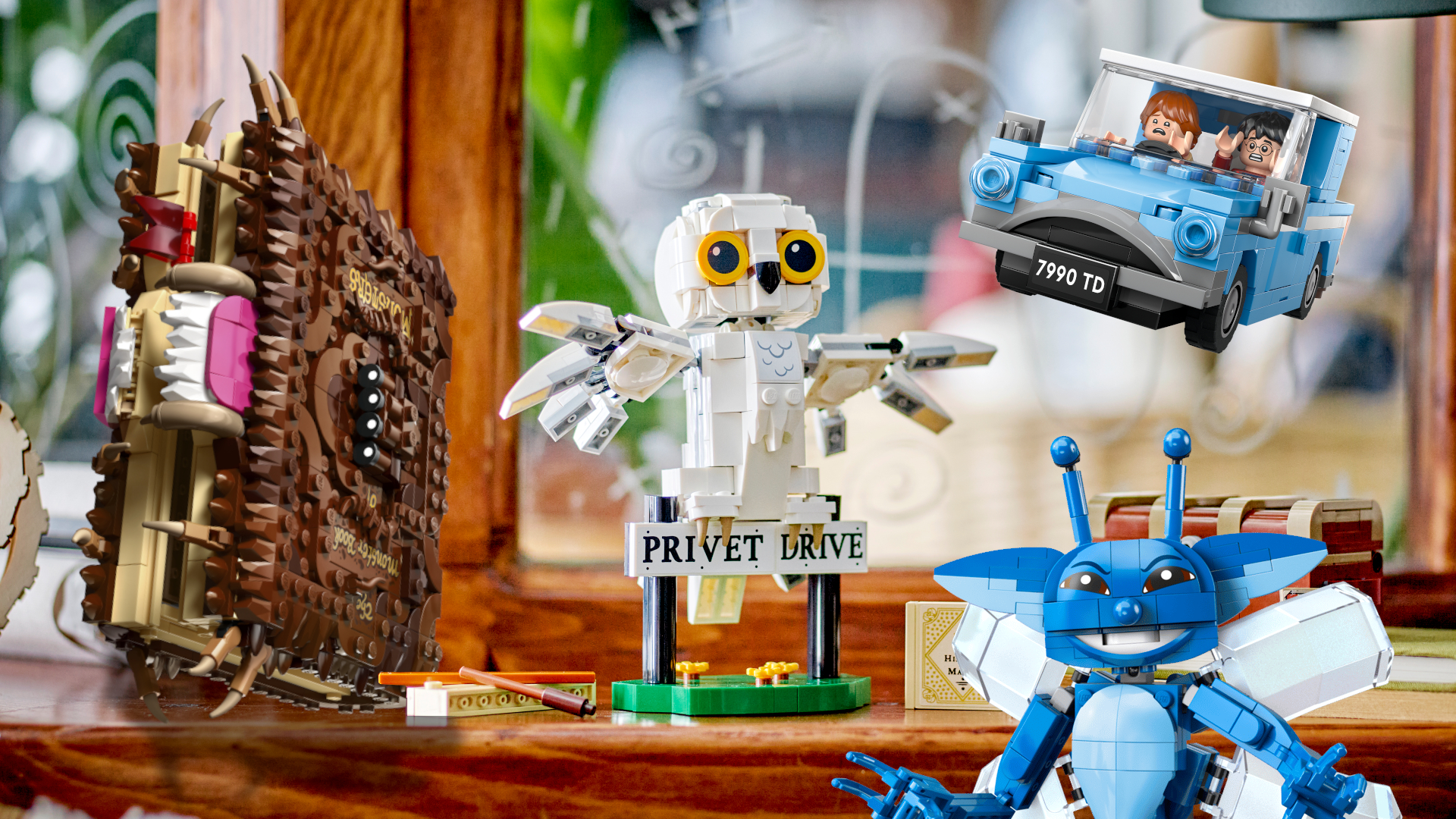 Lego Monster Book of Monsters, Hedwig, Ford Anglia, and Cornish Pixie on a wooden classroom background