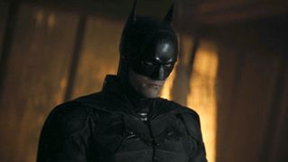 Batman (Robert Pattinson) looks ahead in The Batman.