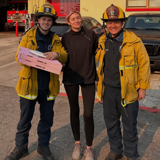 Photo of Caroline D’Amore and two firefighters.