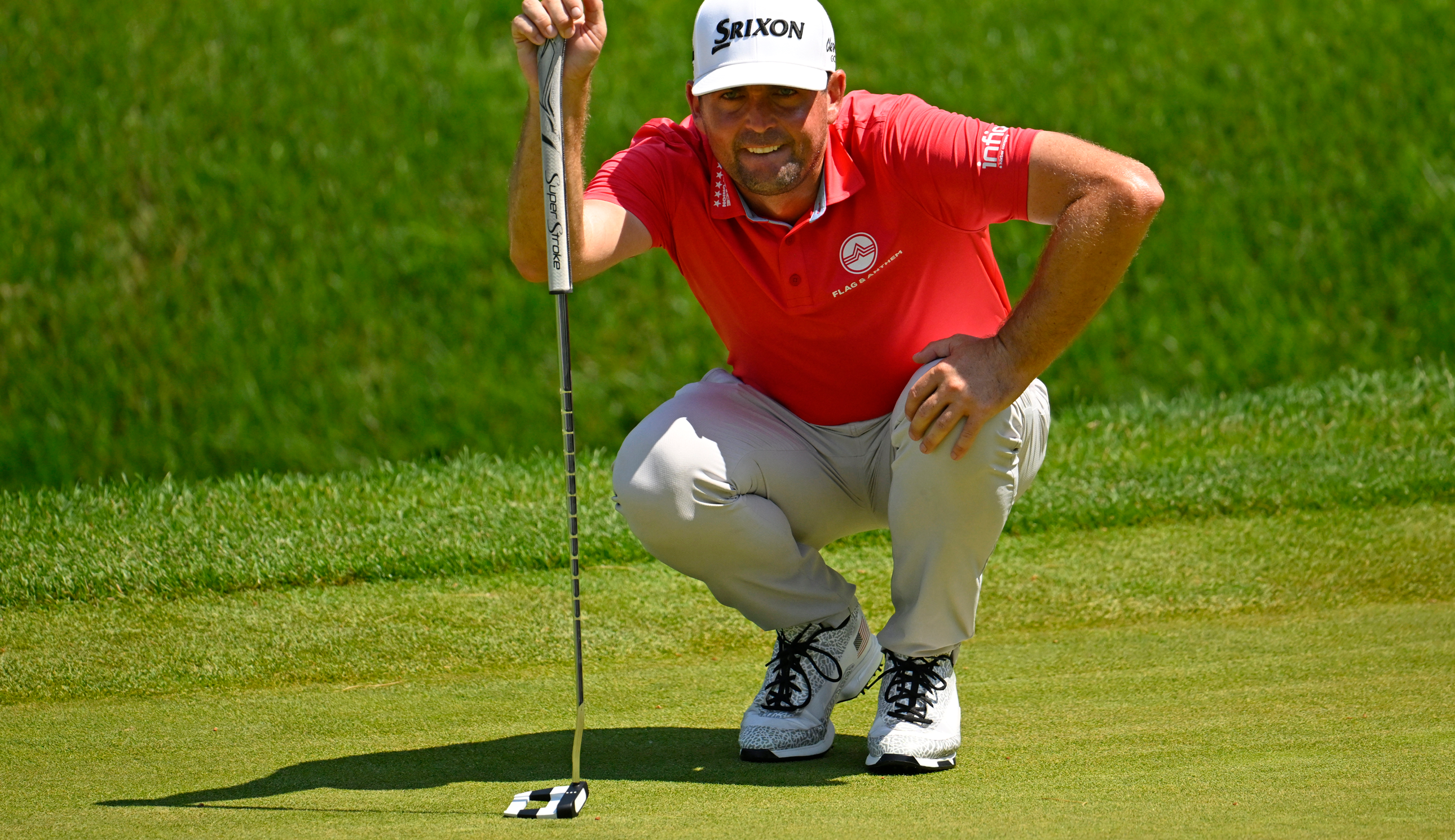 Keegan Bradley lines up a putt