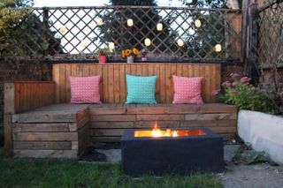 small DIY fire pit on a patio with pallet furniture