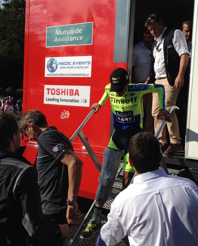Alberto Contador emerges from the medical station with a leg brace after his stage 10 crash