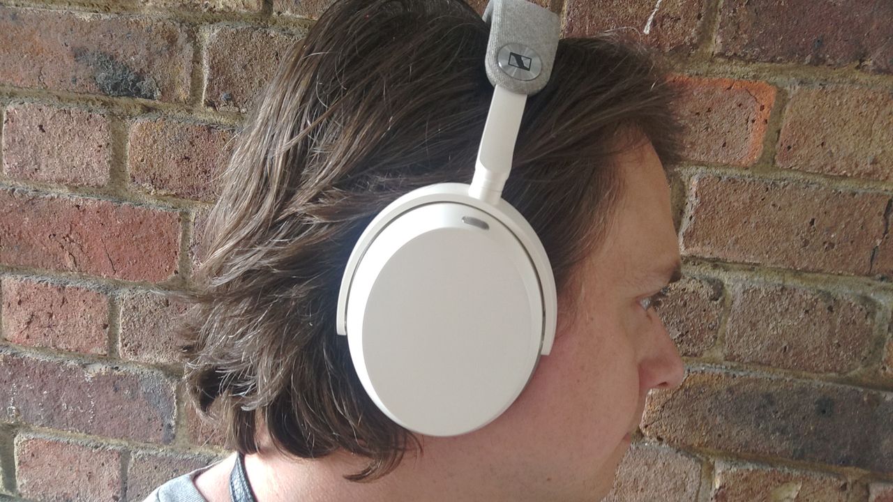 Photograph of man wearing Sennheiser Momentum 5 headphones