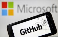Github logo on a phone screen with a cracked display, with Microsoft's logo blurred in the background via depth of field. 