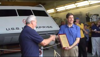 "Star Trek" superfan Adam Schneider (right) receives a plaque from Hans Mikatis of Master Shipwrights, Inc., during the unveiling of the restored Galileo shuttlecraft on June 22, 2013. The Galileo was originally featured on the original "Star Trek" TV series in 1967 and restored by Schneider and his team.