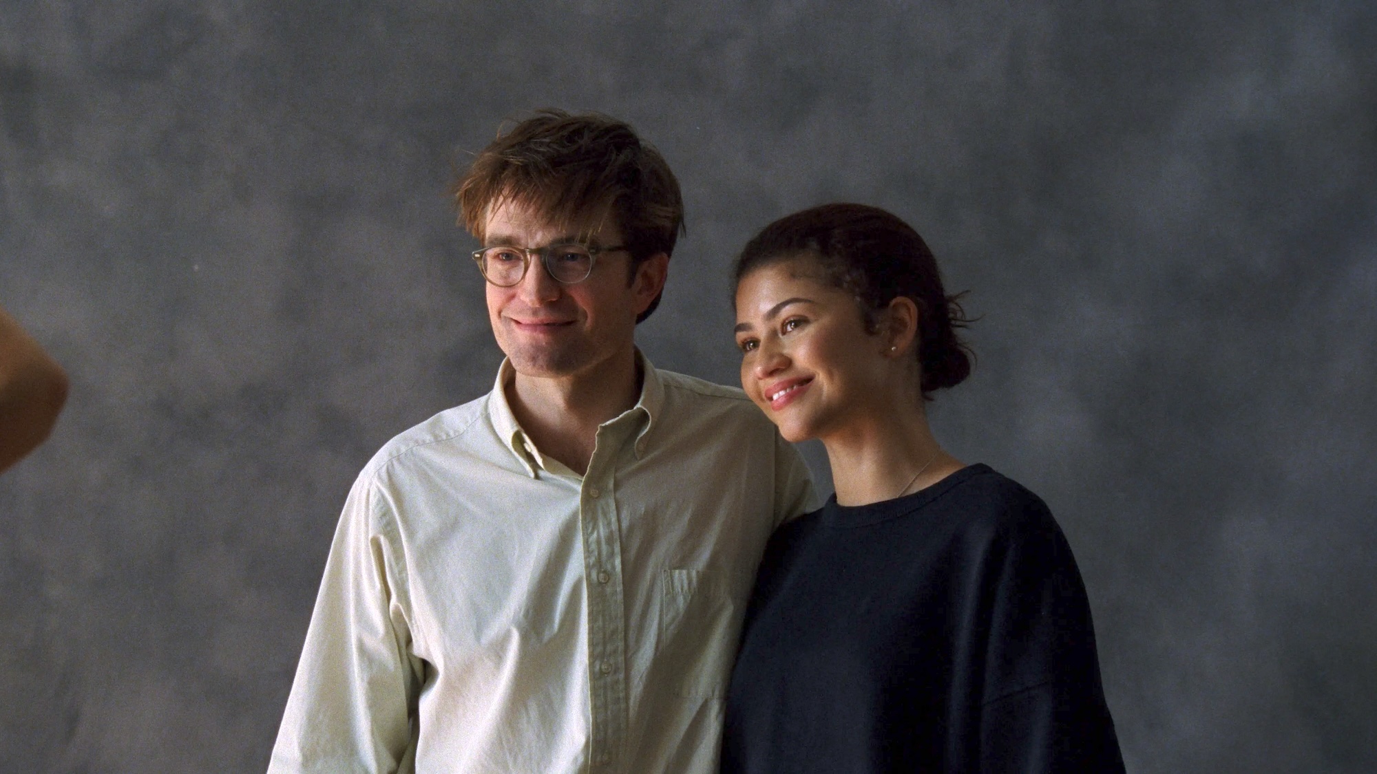Robert Pattinson and Zendaya smiling in The Drama
